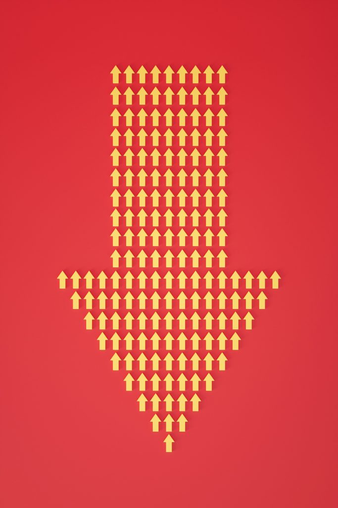 Many small yellow arrows pointing upward, arranged to form one large arrow pointing down.